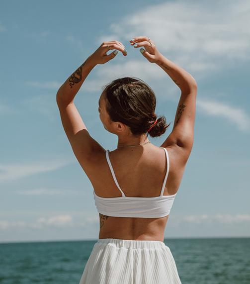 woman at beach happy after prescription management